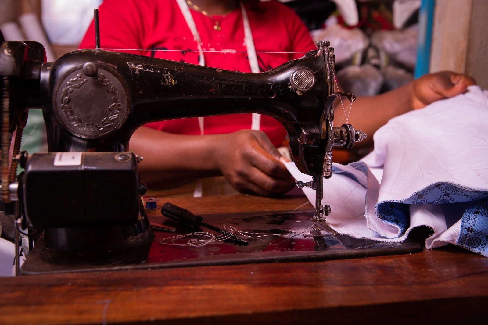 A Shakti Sisters graduate weaving at her loom